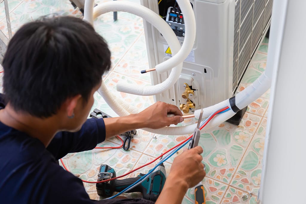 Servicing an Air conditioner with AC Replacement Service by Clean Air Solutions 